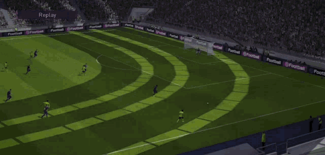 a soccer game is being played in a stadium with a replay sign in the background