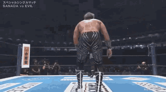 a wrestling match between sanada and evil takes place