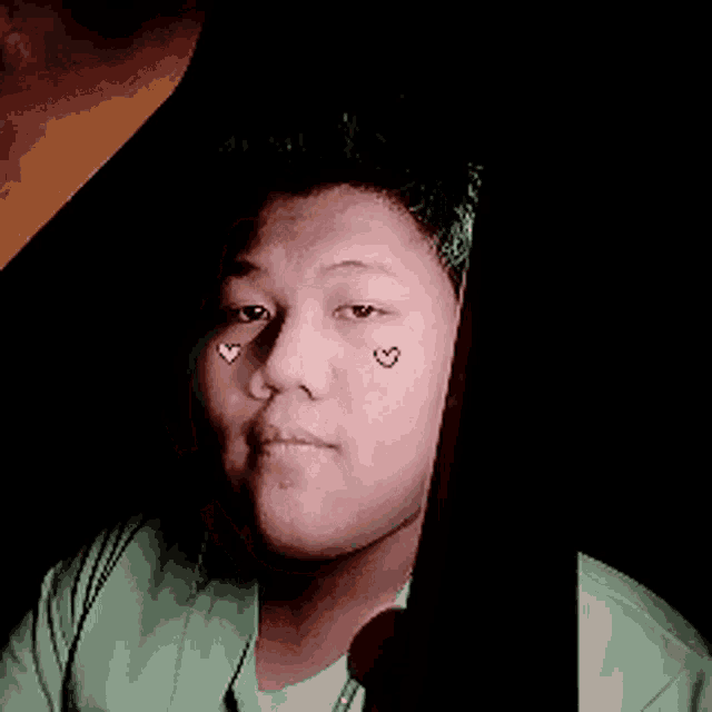 a woman with a heart on her face is giving a thumbs up
