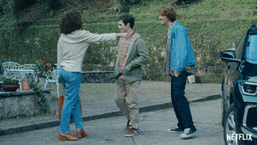 three people standing in front of a netflix ad