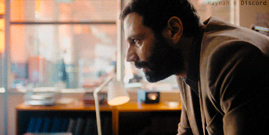 a man with a beard is looking at a computer screen with haynah & discord written on the bottom