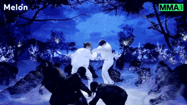 a group of people are dancing in the snow with melon written on the bottom right