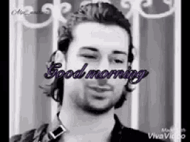 a black and white photo of a man with the words `` good morning '' written on his face .