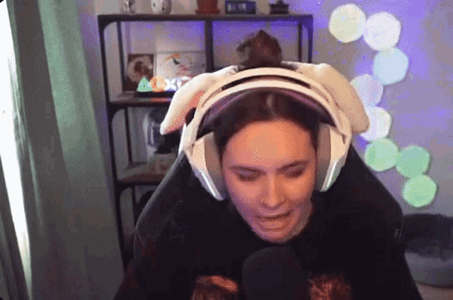 a woman wearing bunny ears and headphones is sitting in a chair