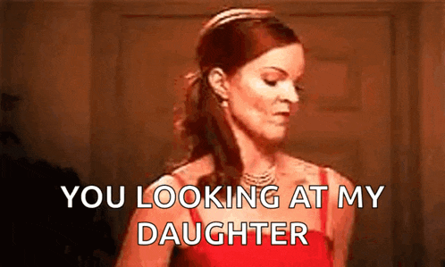 a woman in a red dress is standing in front of a door and says `` you looking at my daughter '' .