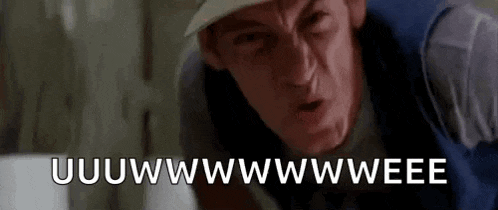 a man wearing a hat and a vest is making a funny face and says uwwwwwwwwweeee .