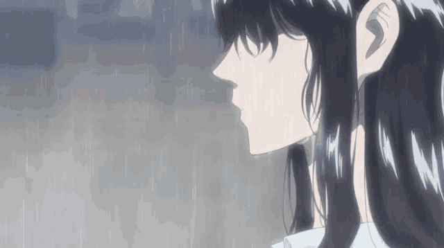 a close up of a girl 's face in the rain