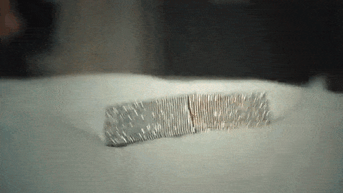 a close up of a bracelet with diamonds on a white surface .