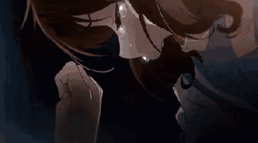 a close up of a person with tears coming out of their eyes .