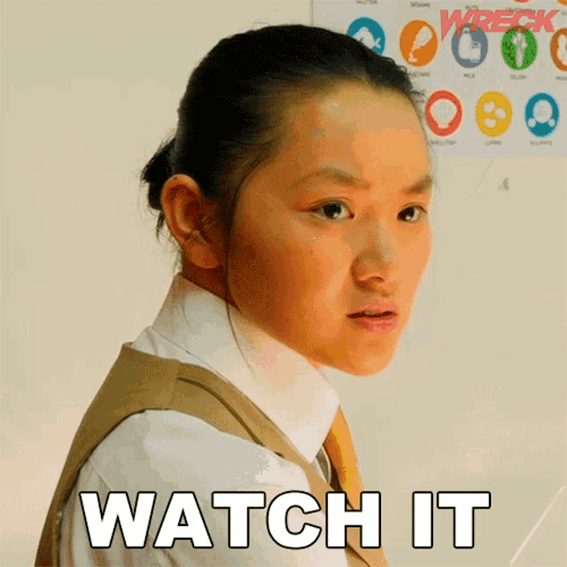 a girl in a school uniform is making a face and says watch it