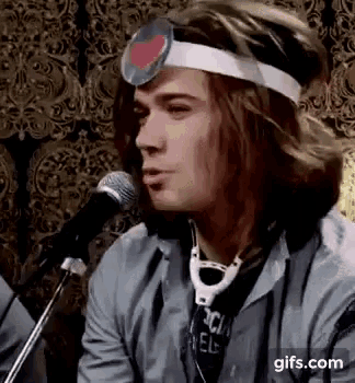 a man wearing a headband with a heart on it and a stethoscope around his neck .
