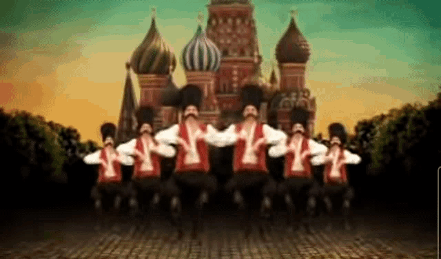 a group of men are dancing in front of a russian building