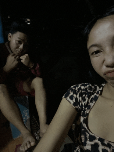 a girl in a leopard print shirt sits next to a boy in a red shirt