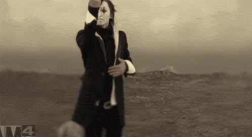 a black and white photo of a man with a mask and the number 4 in the corner