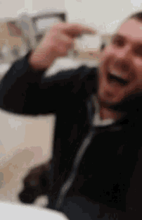 a blurry picture of a man laughing with his mouth open