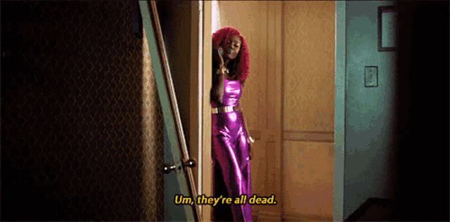 a woman in a purple jumpsuit is talking on a cell phone and says " um they 're all dead "