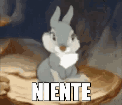 a cartoon rabbit is sitting on top of a rock with the word niente written above it .