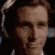 a close up of a man 's face in a suit and tie smiling .
