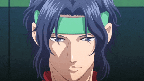 a man with blue hair and a green headband