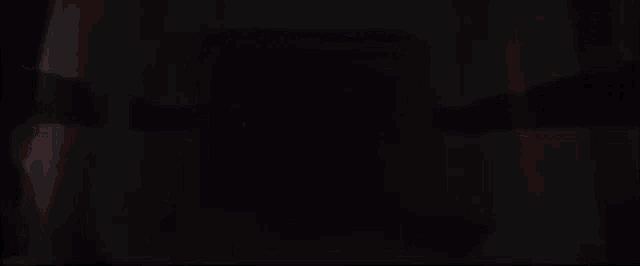 a red light saber is flying in the dark with the words `` lord huber has arrived '' above it .
