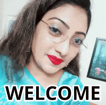 a woman wearing glasses and red lipstick is standing in front of the word welcome