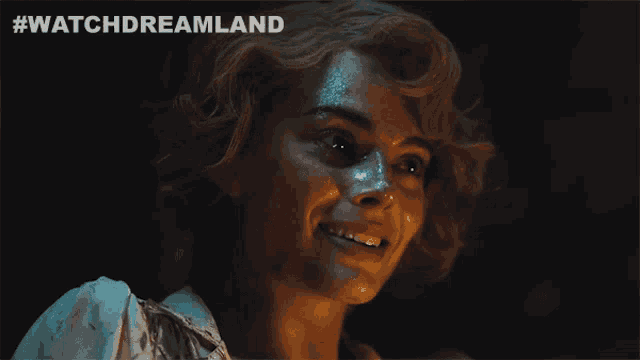 a close up of a woman 's face with #watchdreamland written on the bottom right