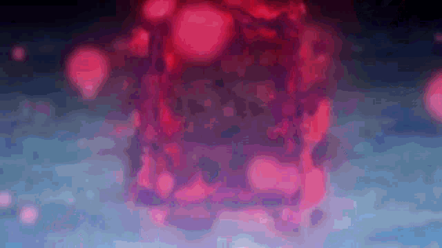 a blurry picture of a red cube in the middle of a dark room