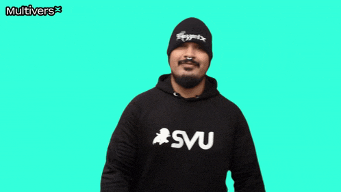 a man making a heart with his hands in front of a green background that says multivers