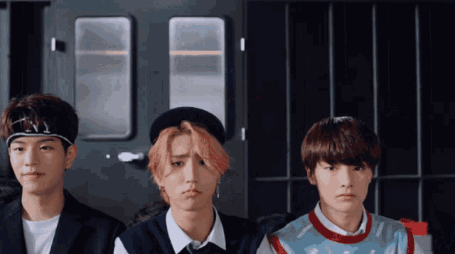 three young men are standing next to each other with one wearing a headband that says ' ny ' on it