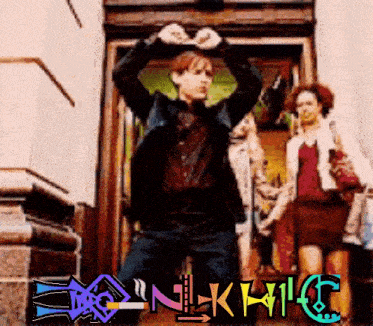 a man is making a heart shape with his hands in front of a sign that says ' nlk14c '