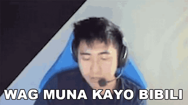 a man wearing headphones and a microphone is sitting in a chair and saying wag muna kayo bibili .