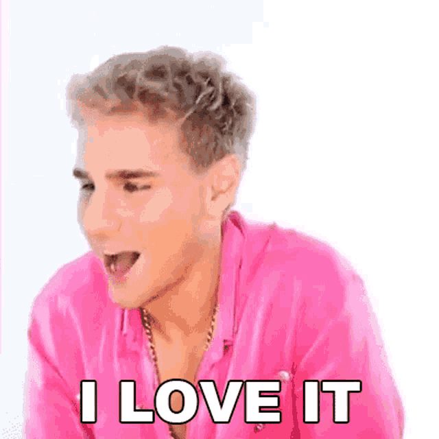 a young man in a pink shirt is making a funny face and saying `` i love it '' .