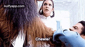 a man and a woman are standing next to each other and a chewie is standing next to them .