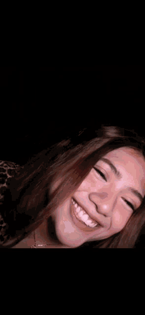 a close up of a woman 's face with her eyes closed and her mouth open .