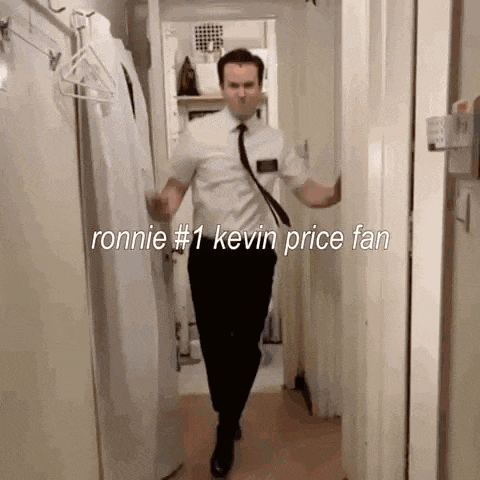 a man in a suit and tie is walking down a hallway .