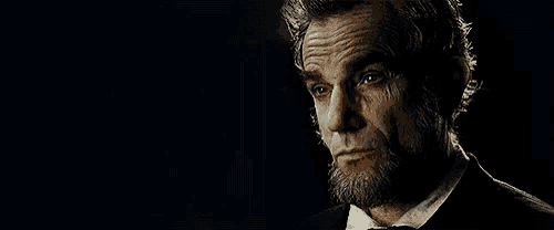 a man with a beard and mustache is wearing a suit and tie