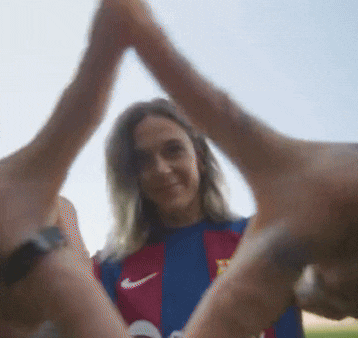 a blurry picture of a woman giving a high five