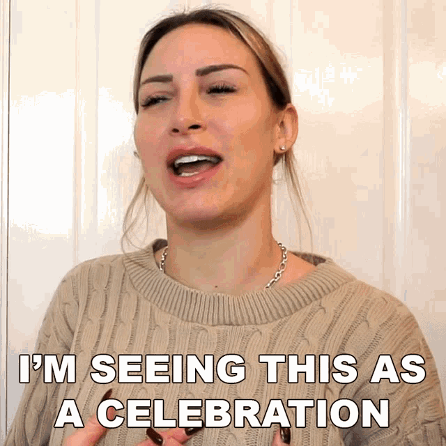 a woman wearing a sweater says i 'm seeing this as a celebration