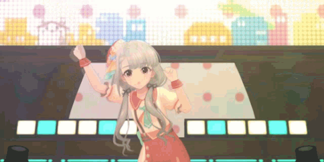 a girl in a red dress is dancing on a stage in front of a screen