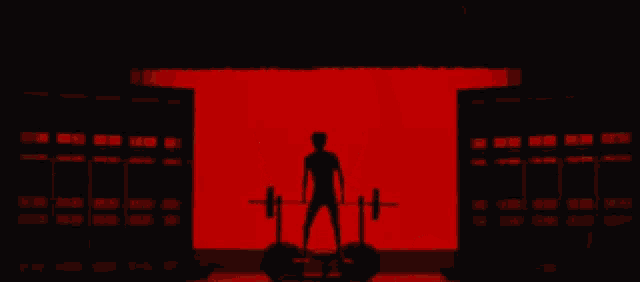 a naked man is standing in front of a red background with his arms outstretched .
