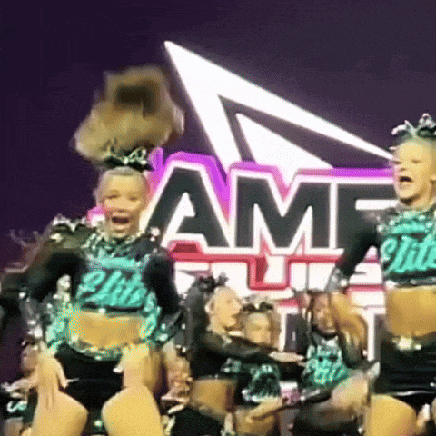 a group of cheerleaders are dancing in front of a sign that says amf