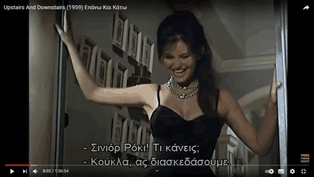 a video of a woman in a black dress is titled upstairs and downstairs ( 1959 )
