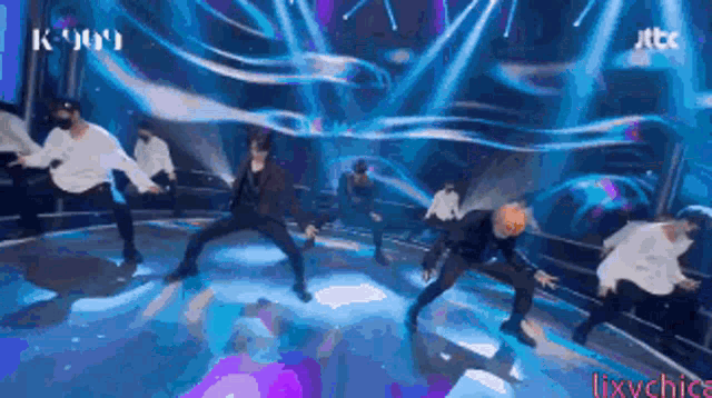 a group of people are dancing on a stage with jtbc written on the bottom right