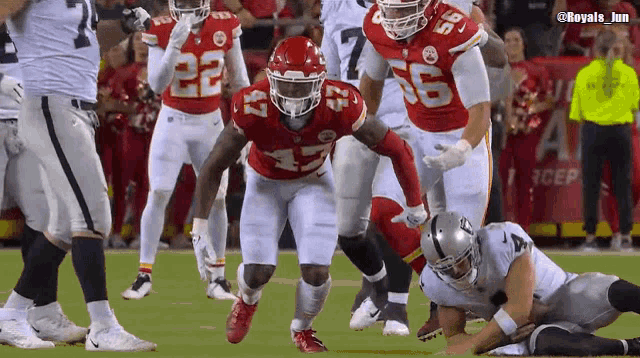 a football player with the number 15 on his jersey is running