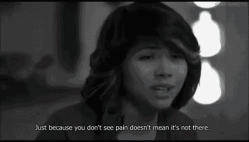 a woman is crying in a black and white photo with a quote that says just because you don 't see pain