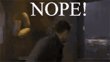 a man is standing in front of a sign that says nope !