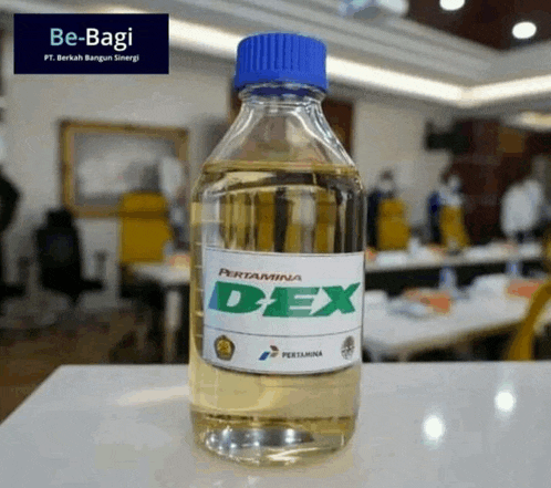 a bottle of pertamina dex sits on a white table