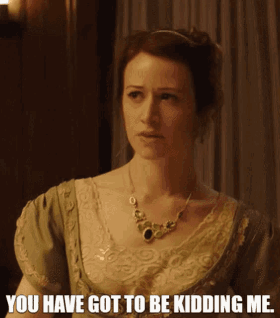 a woman wearing a green dress and a necklace says you have got to be kidding me