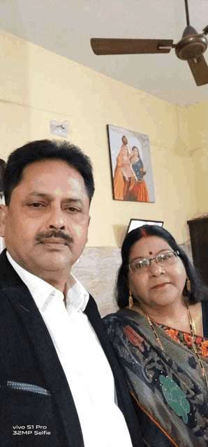 a man and woman are posing for a selfie with a vivo s1 pro phone