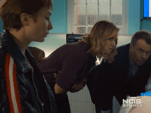 a poster for ncis sydney shows a man and a woman